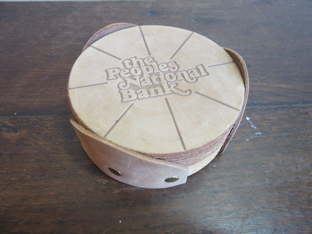 Leather advertising drink coasters. The Peoples National Banl