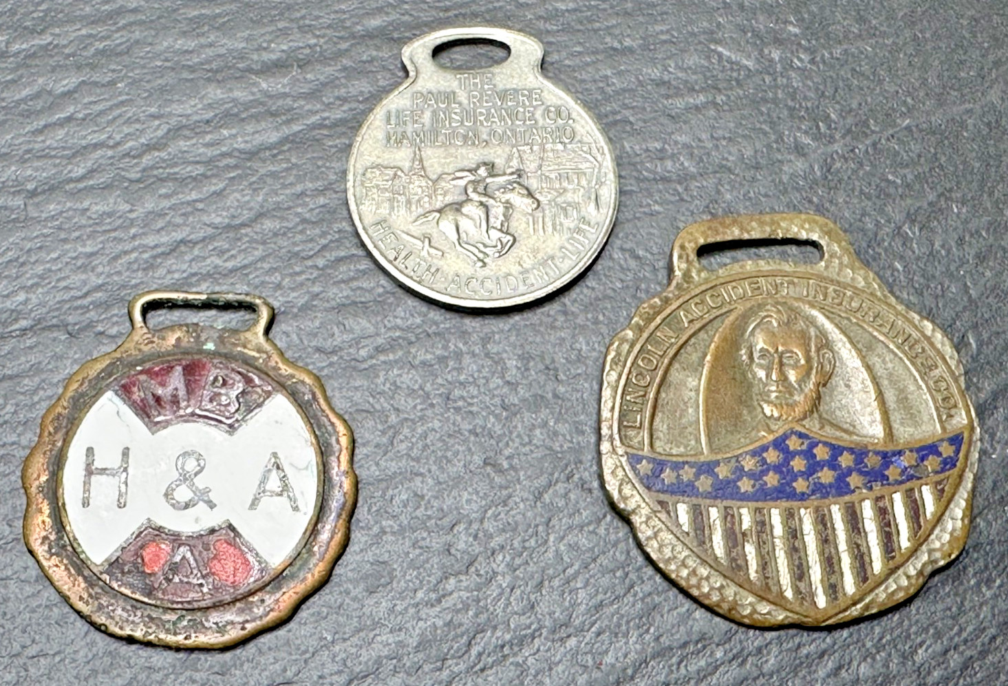 THREE VINTAGE INSURANCE ADVERTISING FOBS: H&A PAUL REVERE LINCOLN ACCIDENT N786