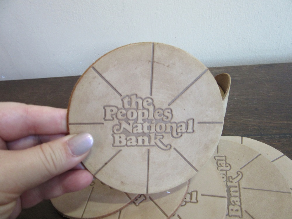 Leather advertising drink coasters. The Peoples National Banl