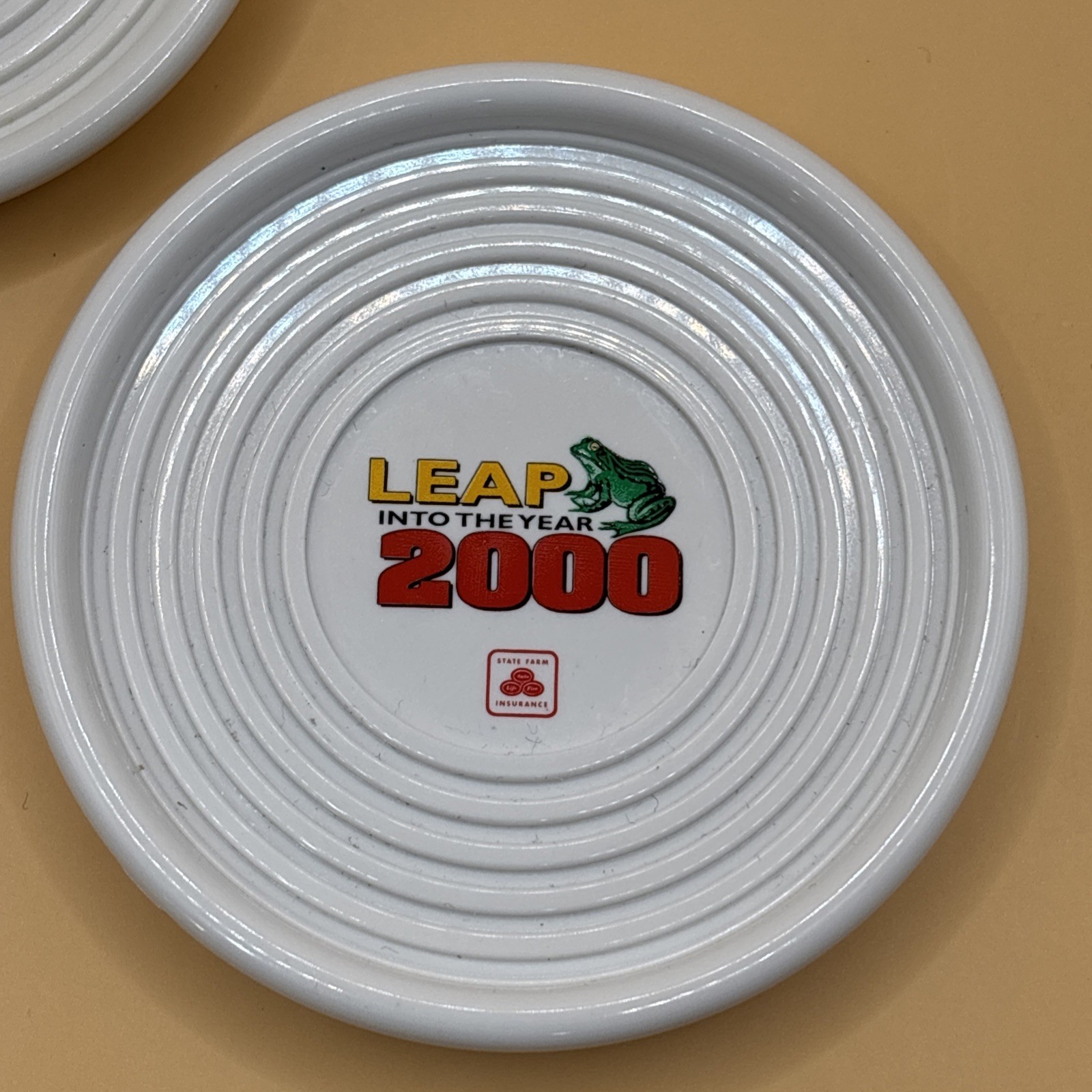 2000 Lot of Two (2) State Farm “Leap into the Year” Plastic 3.5″ Round Coasters