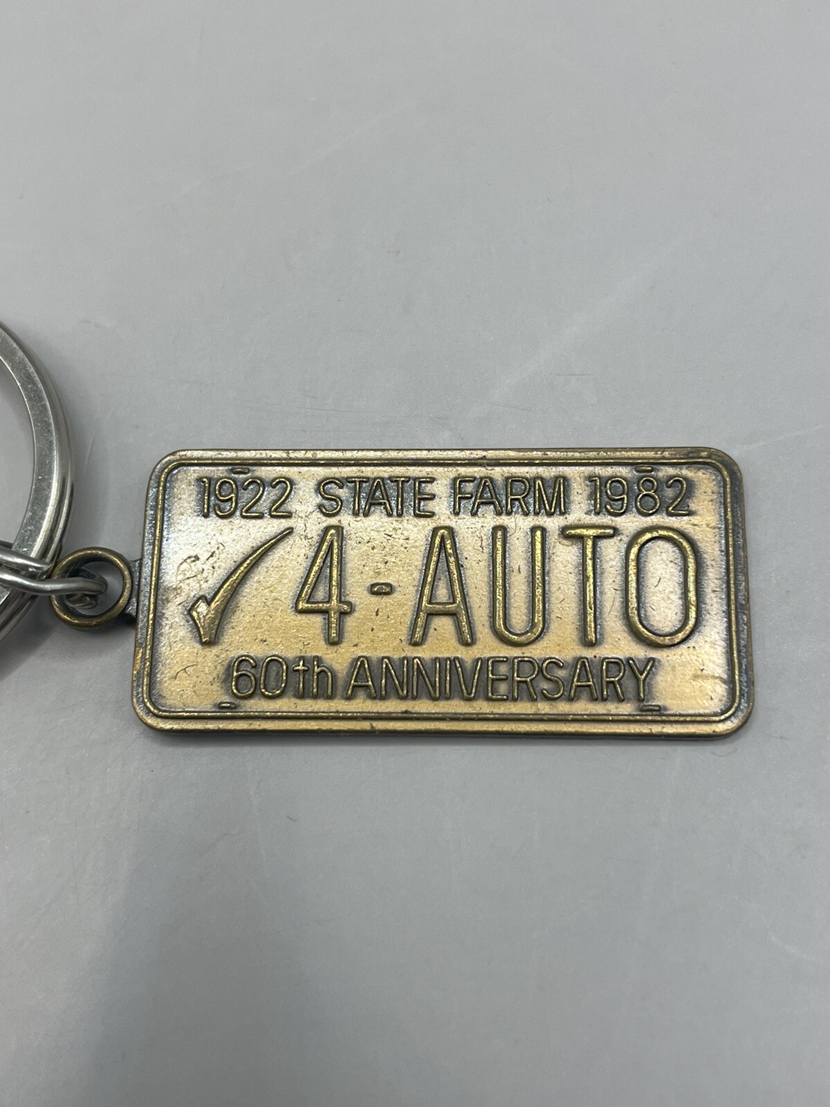 1982 State Farm 60th Anniversary “4-AUTO” License Plate Metal Keychain-2.5″ Long